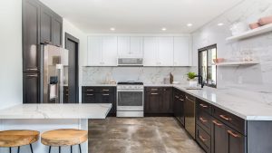 a simple white kitchen interior with small marble island and wooden kitchen cabinets installed by mykitchencabinets