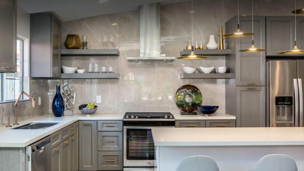 a tiled walling kitchen interior with marble island and wooden cabinets from mykitchencabinets