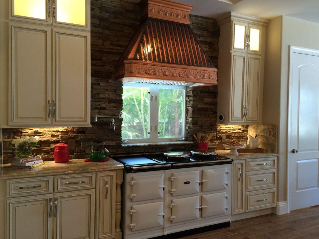 a kitchen with wooden style exhaust hood and white wooden kitchen cabinets installed by mykitchencabinets