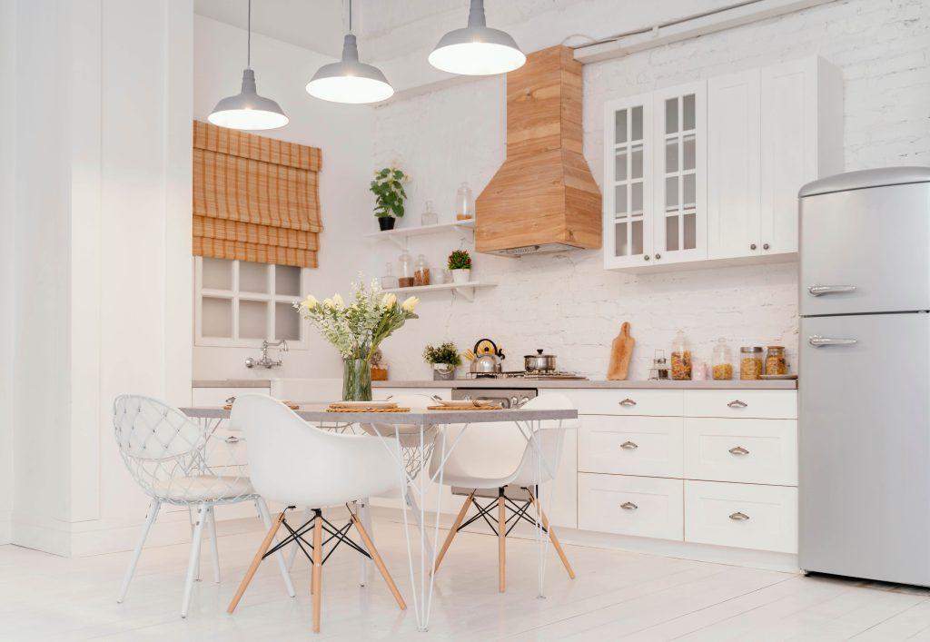a white kitchen interior design with wooden style exhaust hood and wooden cabinets installed by mykitchencabinets
