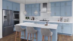 a kitchen with white marble island, white stools and light blue wooden cabinets installed by mykitchencabinets